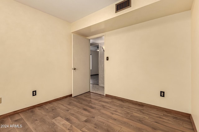 spare room with wood-type flooring