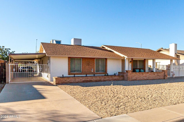 ranch-style house with a carport and covered porch