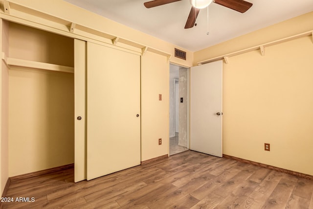 unfurnished bedroom with ceiling fan and light hardwood / wood-style flooring