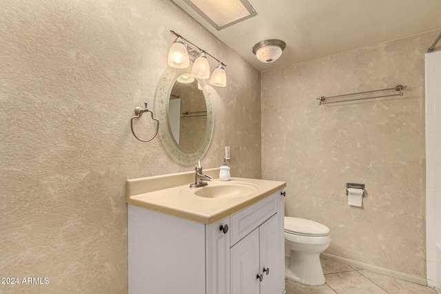 bathroom with tile patterned floors, vanity, and toilet