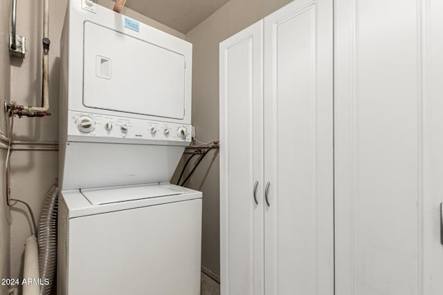 laundry room with stacked washing maching and dryer