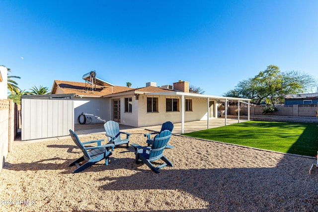 back of house featuring a patio area and a yard