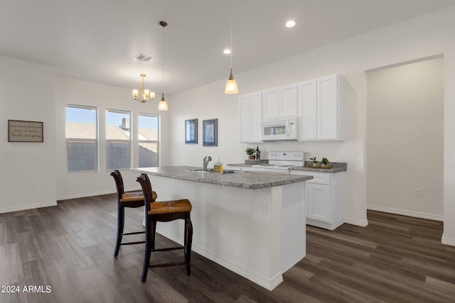 kitchen featuring an island with sink, dark hardwood / wood-style floors, white appliances, and white cabinets