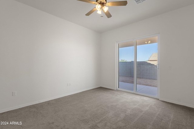 carpeted spare room featuring ceiling fan