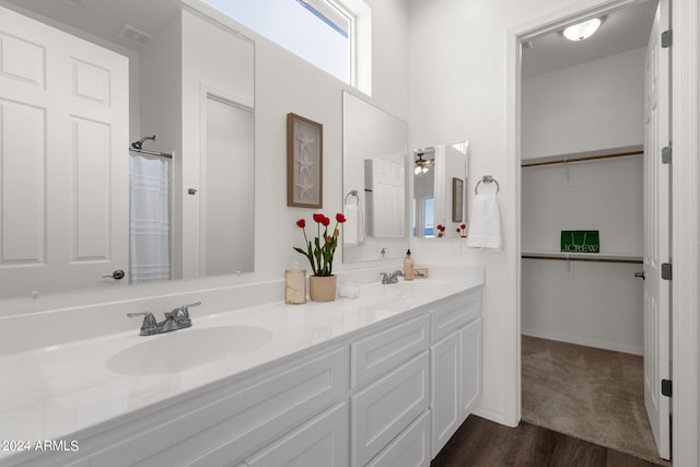 bathroom featuring hardwood / wood-style floors, ceiling fan, a shower with shower curtain, and vanity