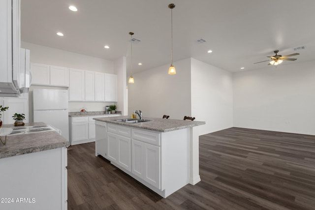 kitchen featuring pendant lighting, ceiling fan, white cabinets, and dark wood-type flooring