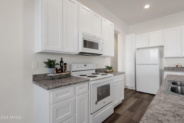 kitchen featuring white cabinets, white appliances, dark hardwood / wood-style flooring, and sink