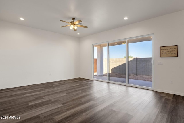 unfurnished room featuring dark wood-type flooring and ceiling fan