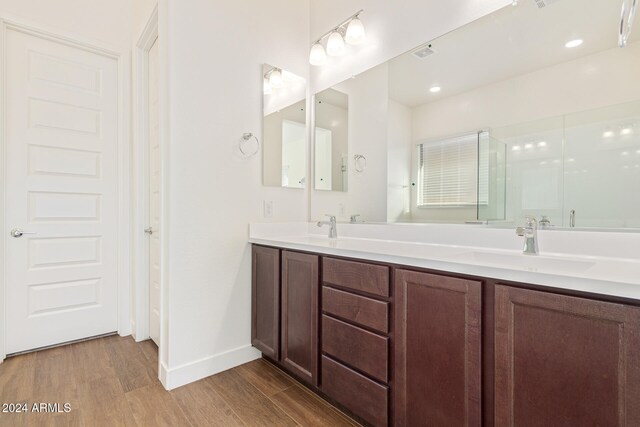 bathroom with hardwood / wood-style flooring and vanity