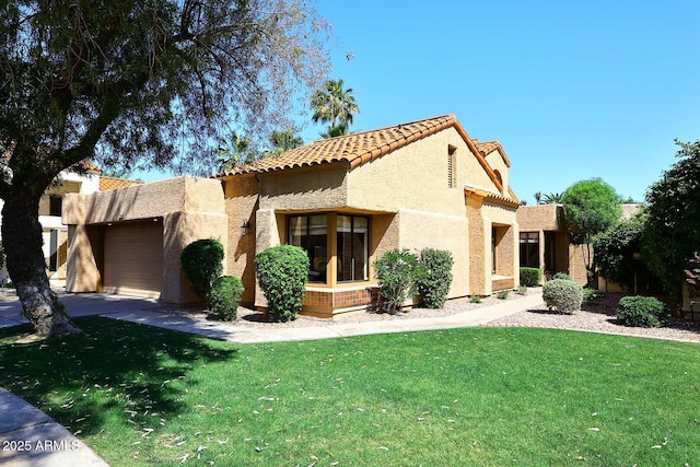 9115 N 101st Way, Scottsdale, AZ 85258 - mediterranean / spanish home featuring a garage, stucco siding, a tiled roof, and a front yard