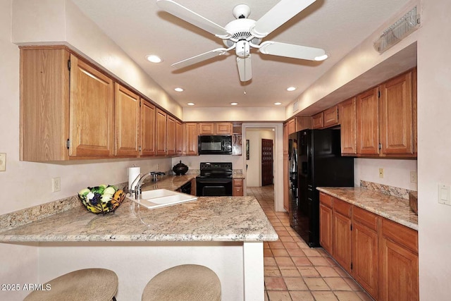 9115 N 101st Way, Scottsdale, AZ 85258 - kitchen featuring black appliances, a sink, ceiling fan, a peninsula, and light stone countertops
