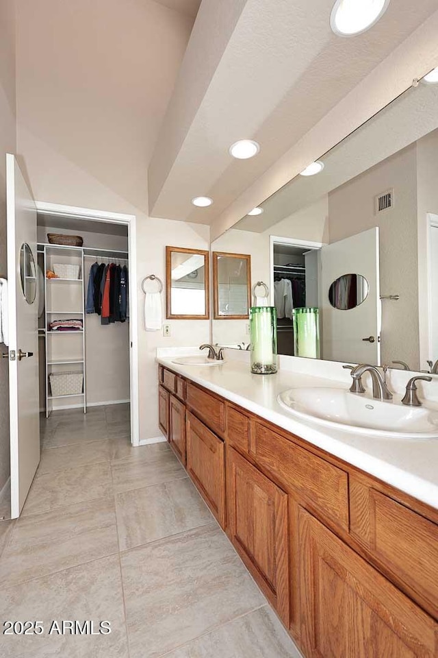 9115 N 101st Way, Scottsdale, AZ 85258 - bathroom with a spacious closet, double vanity, and recessed lighting