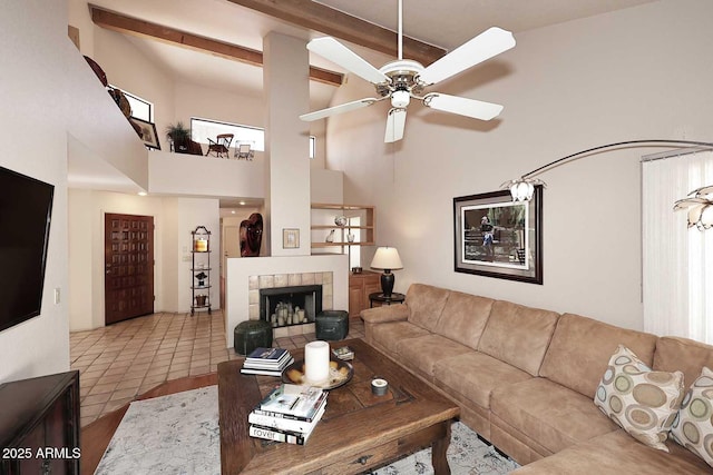 9115 N 101st Way, Scottsdale, AZ 85258 - tiled living room with a towering ceiling, ceiling fan, beamed ceiling, and a fireplace