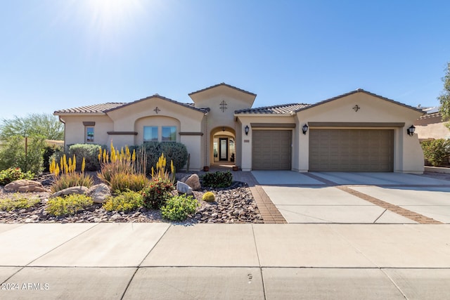 mediterranean / spanish-style home featuring a garage