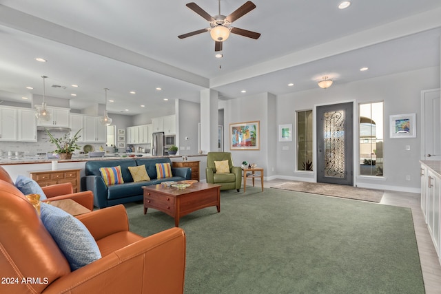 living room featuring light wood-type flooring and ceiling fan