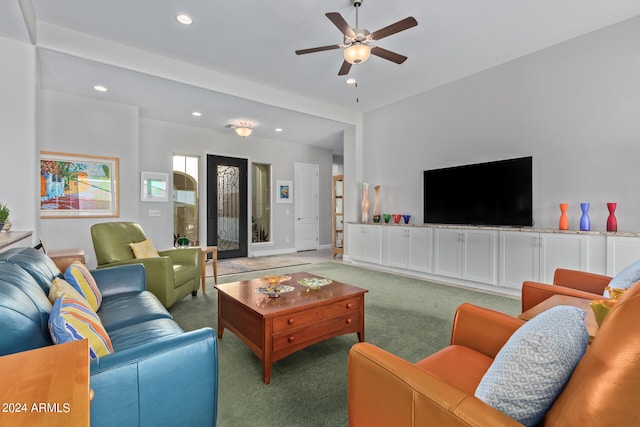 carpeted living room with ceiling fan