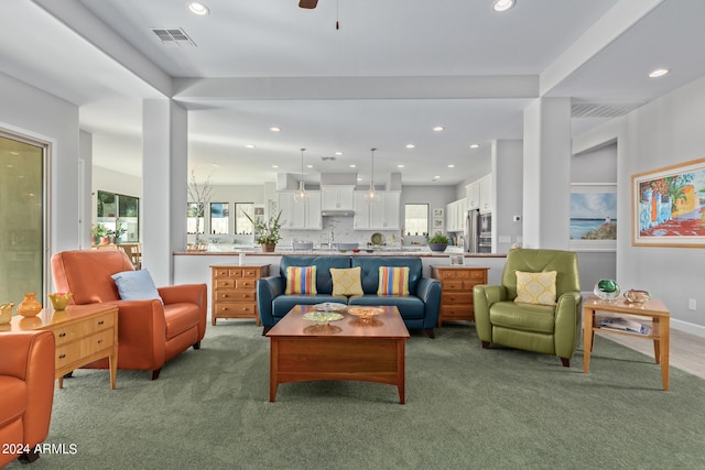 carpeted living room featuring ceiling fan