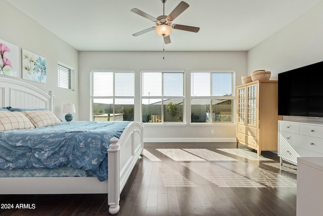 bedroom with ceiling fan and dark hardwood / wood-style floors