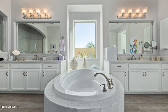 bathroom featuring independent shower and bath and vanity