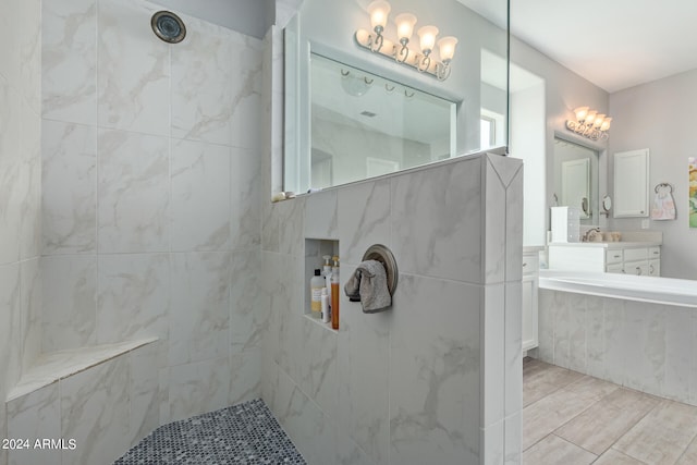 bathroom with vanity and a tile shower