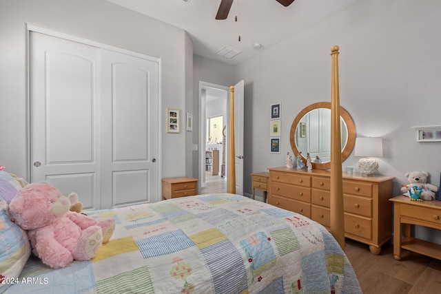 bedroom with light hardwood / wood-style floors, ceiling fan, and a closet