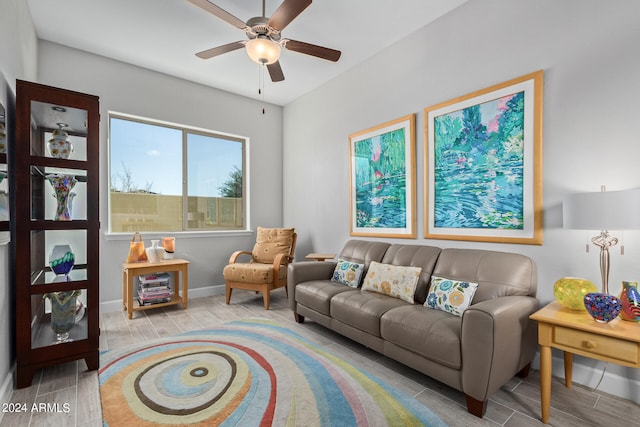 living room featuring light hardwood / wood-style floors and ceiling fan