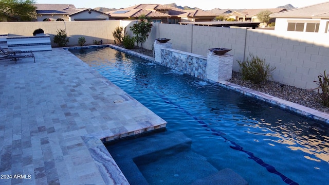 view of swimming pool with pool water feature