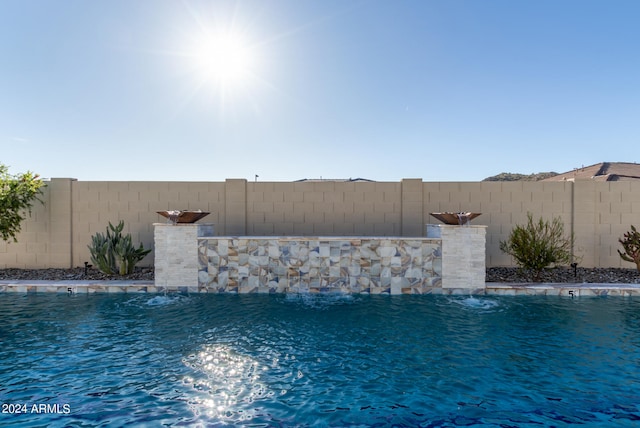 view of swimming pool with pool water feature