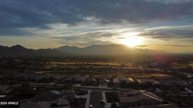 aerial view at dusk featuring a mountain view