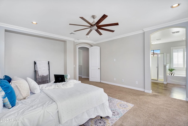 carpeted bedroom featuring visible vents, arched walkways, baseboards, and ornamental molding