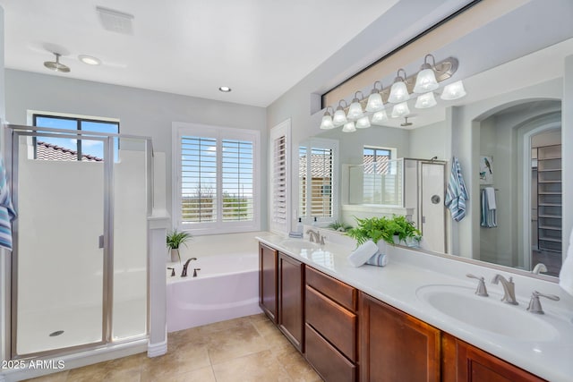 bathroom with a sink, visible vents, a bath, and a shower stall