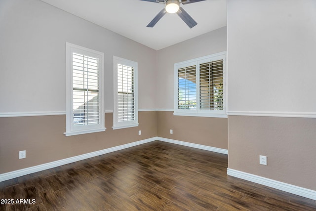 empty room featuring dark wood-style floors, baseboards, and ceiling fan