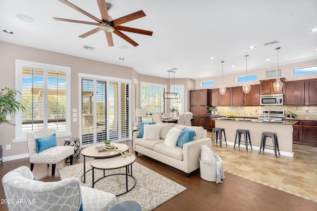living area featuring visible vents, recessed lighting, light wood-style floors, and a ceiling fan