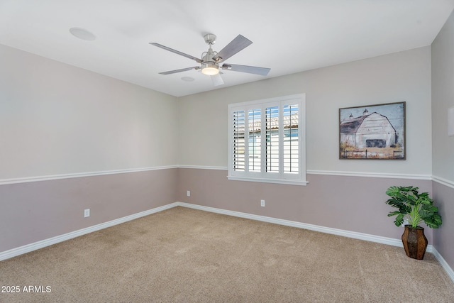 carpeted spare room with baseboards and ceiling fan