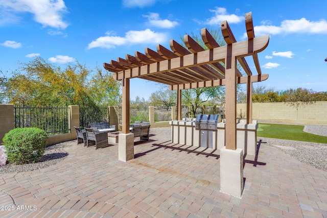 view of patio with fence, area for grilling, exterior kitchen, and a pergola