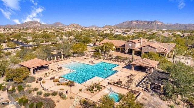 community pool with a gazebo, fence, a patio area, and a mountain view