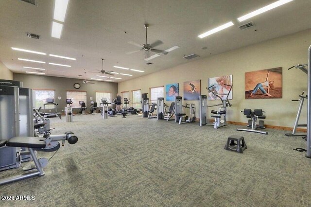 workout area with a wealth of natural light, visible vents, and a ceiling fan