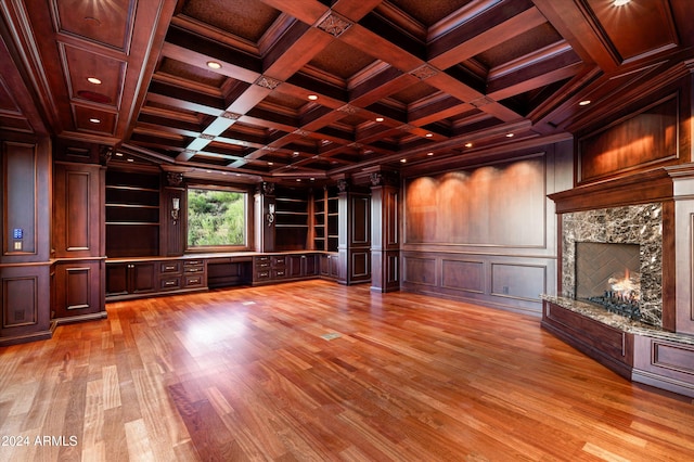 unfurnished living room with wooden ceiling, light hardwood / wood-style floors, beam ceiling, coffered ceiling, and a high end fireplace