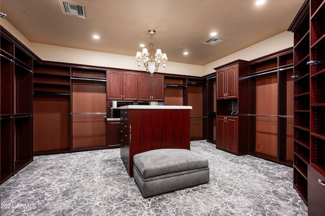 spacious closet with a notable chandelier