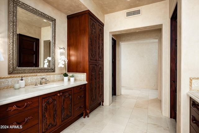 bathroom with vanity, tile patterned floors, and backsplash