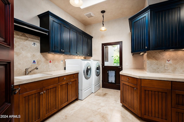 clothes washing area featuring cabinets, separate washer and dryer, and sink