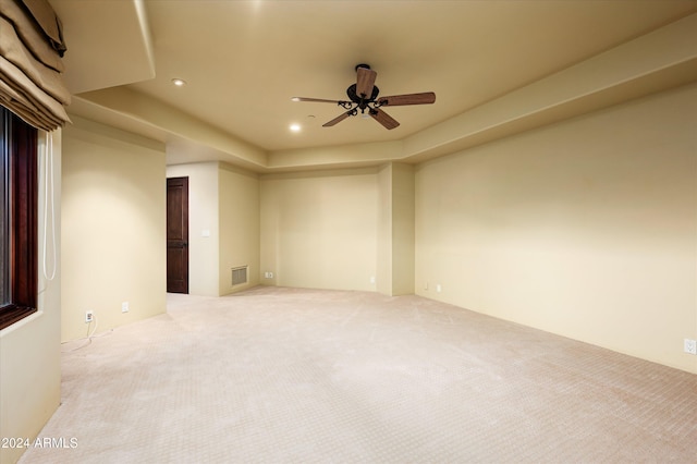 unfurnished room featuring light colored carpet and ceiling fan