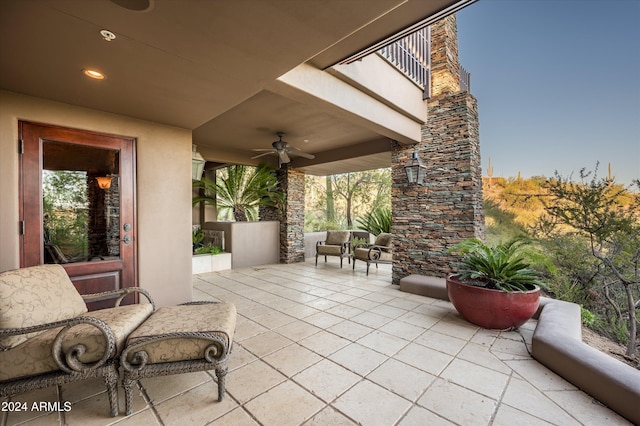 view of patio / terrace featuring ceiling fan and a balcony