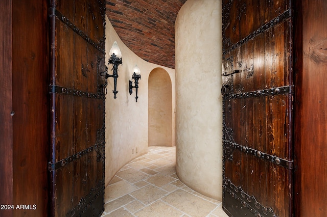 corridor with vaulted ceiling