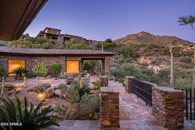 patio terrace at dusk with a mountain view