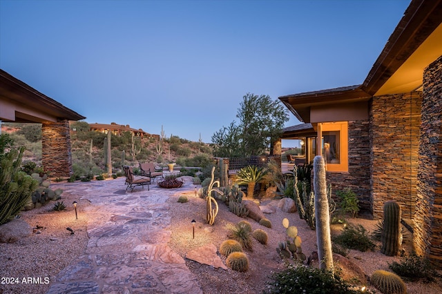 view of yard featuring an outdoor fire pit, a mountain view, and a patio