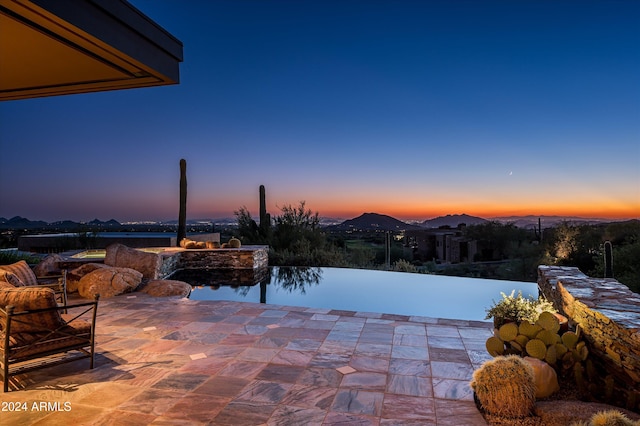 view of patio terrace at dusk