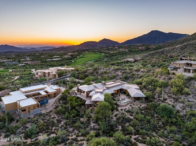 aerial view at dusk featuring a mountain view