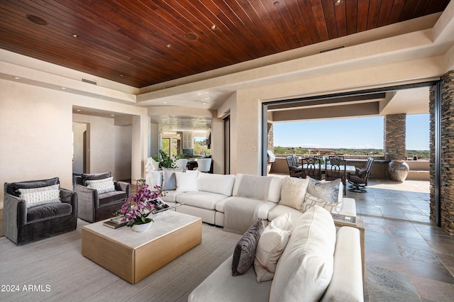 living room featuring a tray ceiling and wood ceiling