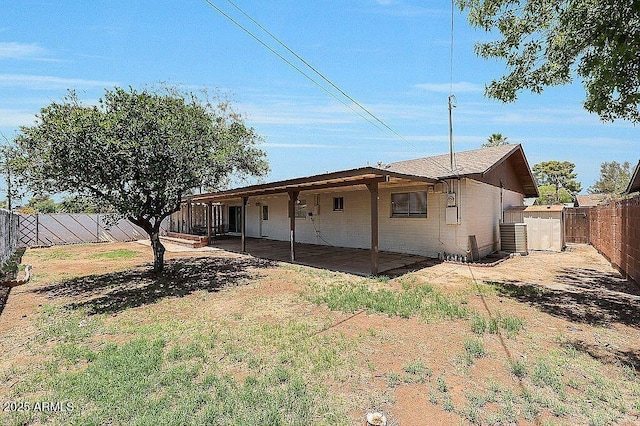 exterior space featuring central AC unit, a fenced backyard, and a patio area